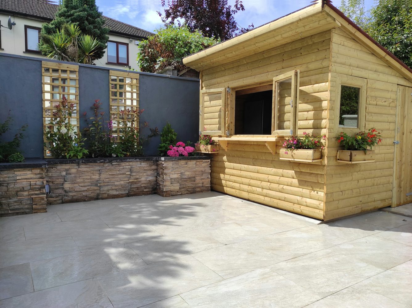 House with a sandstone-paved patio and outdoor seating