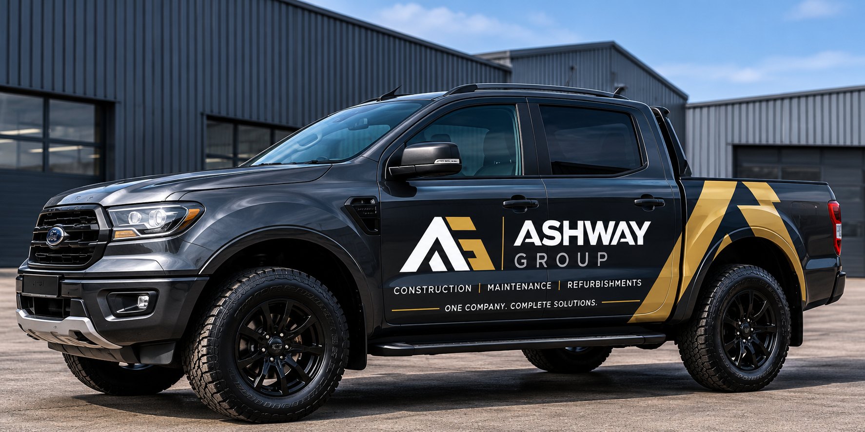 Black Ashway Group vehicle with gold branding outside a commercial unit